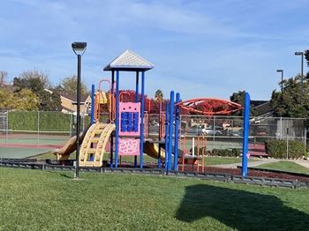 a playground with a swing set and slides